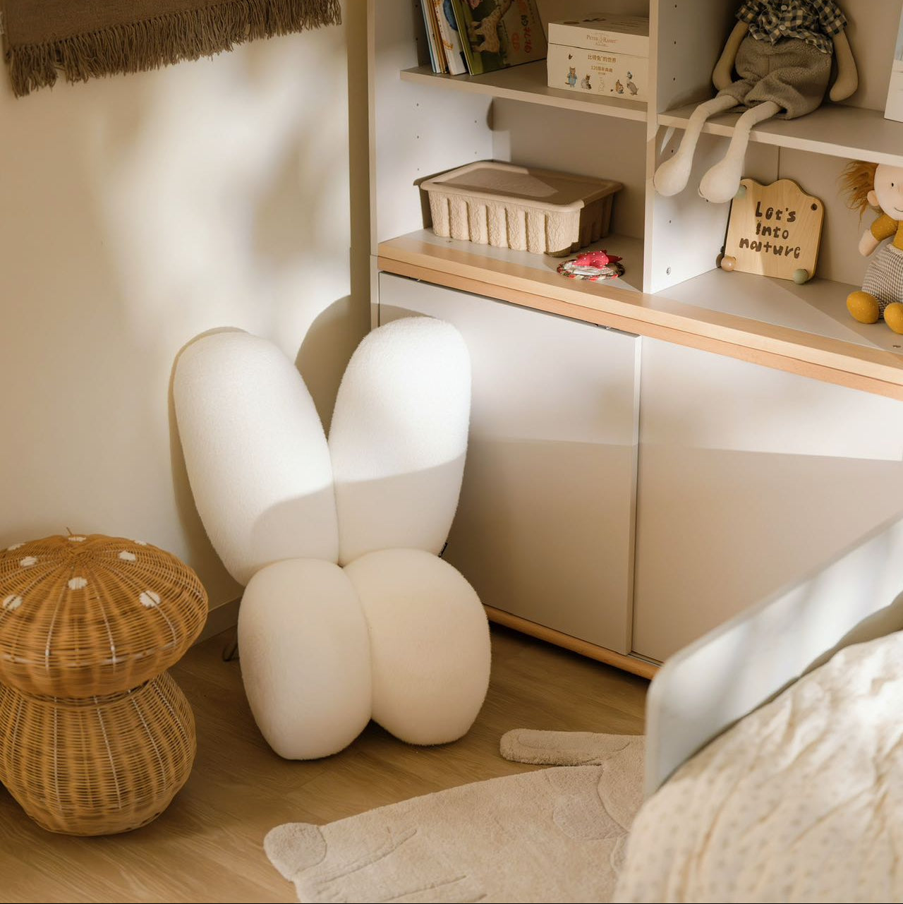 Children's room with a shelf, toys, and a white balloon chair.
