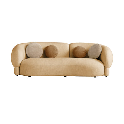 Beige sofa with four round cushions on a white background