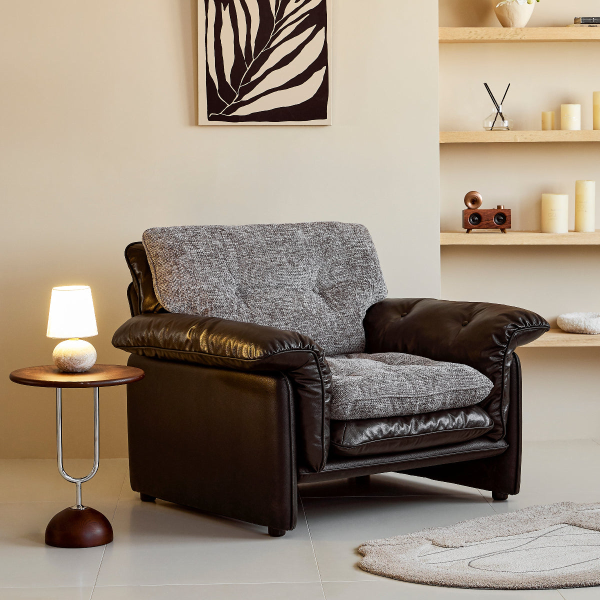 Modern living room with a brown armchair, side table, and wall art.